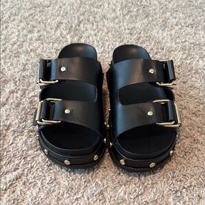 BCBGeneration Black Sandals with Gold Accents